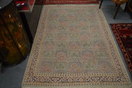 A Persian design rug beige ground with panels of floral decoration 215cm x 155cm.