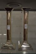 A pair of modern silver plated candlesticks.