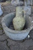 A Greek style jug and a basket weave style circular garden planter.