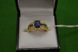 An 18ct gold diamond and synthetic sapphire ring size T.