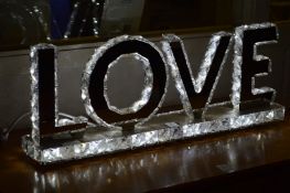 An illuminated sign 'love'.