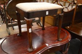 A George III mahogany stool on cabriole legs with pad feet.