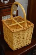 A wicker four bottle carrier.