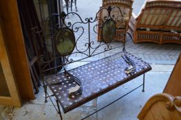 A wrought iron folding garden seat.