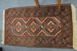 A small Persian rug 110cm x 60cm.
