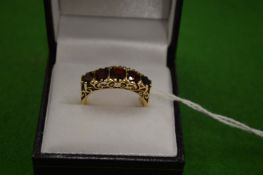 A 9ct gold and garnet five stone ring size R.