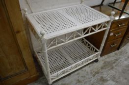 A white painted faux bamboo two tier trolley.
