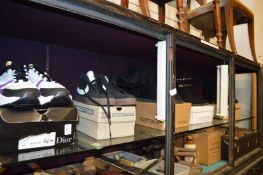 Five boxed pairs of trainers/boots.