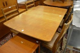 A G plan teak drop leaf gateleg dining table with four ladderback chairs.