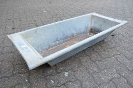 A galvanised rectangular planter/trough.