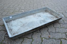 A rectangular galvanised trough or planter.