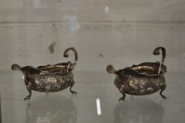 Two similar silver sauce boats.