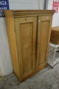 A pine floor standing two door cupboard.