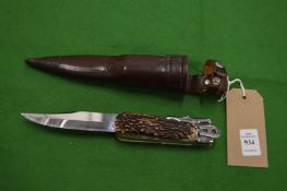 A Linder 'Wolf' no:317119 folding knife with stag horn handle, and 7in blade with leather scabbard.