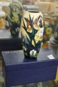 A Moorcroft vase decorated with bull rushes with original box.