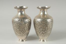 A PAIR OF EARLY 20TH CENTURY SIGNED PERSIAN SILVER VASES, with fine embossed and engraved decoration
