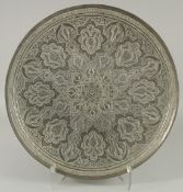 A LARGE QAJAR EMBOSSED AND CHASED WHITE METAL DISH, 48.5cm diameter.