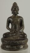 AN EARLY SOUTH EAST ASIAN BRONZE BUDDHA, 12.5cm high.