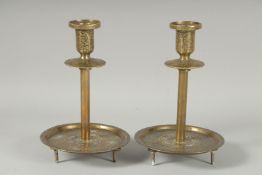 A FINE PAIR OF ISLAMIC SILVER INLAID BRASS CANDLESTICKS, 19cm high.