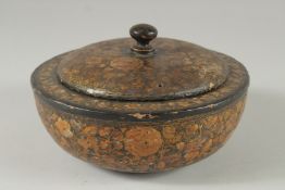 A KASHMIRI CIRCULAR LIDDED BOX, with floral decoration and gilt highlights, 18cm diameter.