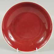 A CHINESE COPPER RED GLAZE PORCELAIN DISH, 22cm diameter.