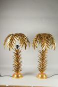 A PAIR OF GILT METAL PALM TREE LAMPS. 26ins high.