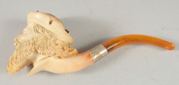 A MEERSCHAUM PIPE CARVED AS A MAN'S HEAD with a long beard and plumed hat. 8cm long, 7cm deep with