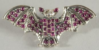 A SILVER RUBY SET BAT BROOCH.