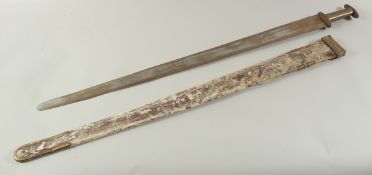 A GERMAN SWORD in a leather scabbard, with brass handle. Inventory No. I L NO 1253. 43ins long.