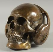 A BRONZE SKULL with headphones.