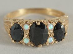 A 9CT GOLD SAPPHIRE AND OPAL RING.
