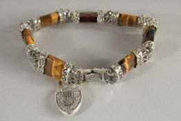 A SCOTTISH, TIGER'S EYE TOGGLE BRACELET AND LOCK.