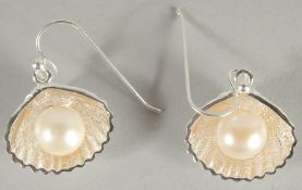 A PAIR OF SILVER PETAL SEA SHELL EARRINGS.