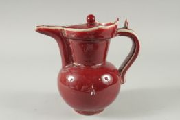 A Chinese red glazed pottery ewer. 12ins high.
