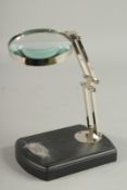 A MAGNIFYING GLASS on a stand.