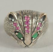 A SILVER CAT'S FACE RING with ruby eyes.