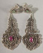 A PAIR OF SILVER, EMERALD & MARCASITE PEACOCK FEATHER DESIGN EARRINGS.
