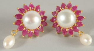 A PAIR OF SILVER AND GOLD PLATED RUBY AND PEARL EARRINGS.