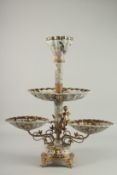 A GOOD BRONZE AND PORCELAIN TABLE CENTREPIECE with cupid supports and painted with birds. 22ins
