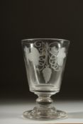 A HEAVY GEORGIAN RUMMER engraved with hops, on a circular base. 5.5ins high.