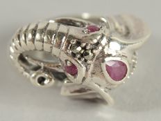 A SILVER RUBY AND MARCASITE ELEPHANT RING.