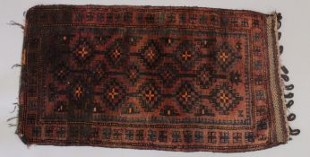 A PERSIAN LOOPED RUG/ CUSHION. 46ins x 26ins.