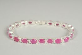 A SILVER RUBY SET LINE BRACELET.