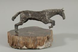 A GOOD CAST SILVER MODEL OF A LEAPING HORSE on an onyx base. 8ins long. London 1981.