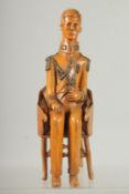A RARE 19TH CENTURY CARVED BOXWOOD FIGURE OF NAPOLEON sitting in a chair. 9ins high.