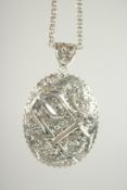 A SILVER ONYX PENDANT AND CHAIN.