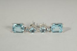 A PAIR OF SILVER BLUE TOPAZ EMERALD CUT DROP EARRINGS.