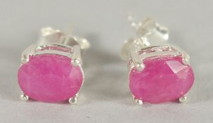 A PAIR OF SILVER AND REAL RUBY STUD EARRINGS.
