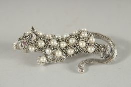 A SILVER PEARL, RUBY ART DECO STYLE PANTHER BROOCH.