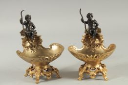 A GOOD PAIR OF GILT AND BRONZE CHERUB SALTS.